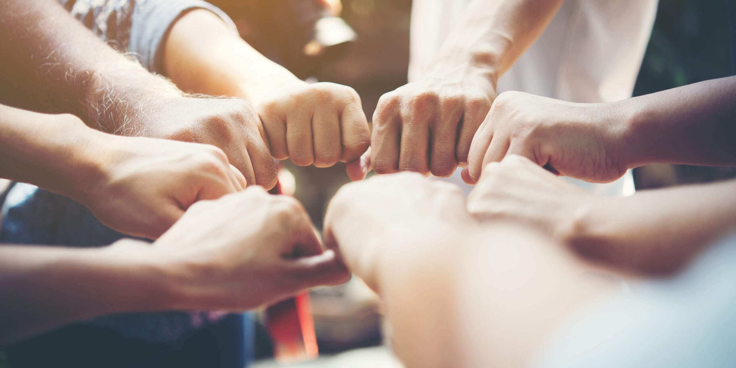 Close up of young people putting their hands together. Team with